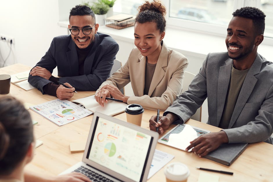 A diverse team of professionals having a meeting in a modern office setting, discussing business strategies